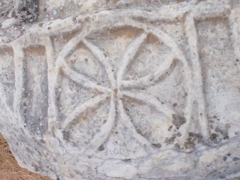 Flower-like solar wheel carved on what appears to be marble, found in the ruins Ephesus, Izmir